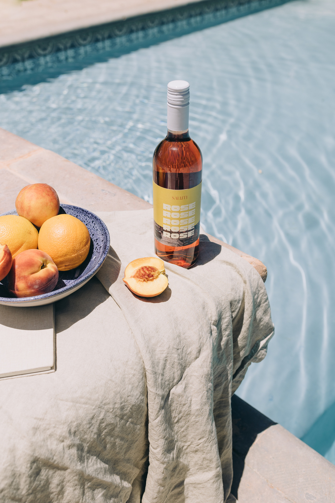 Wine and Fruits on the Table by the Swimming Pool